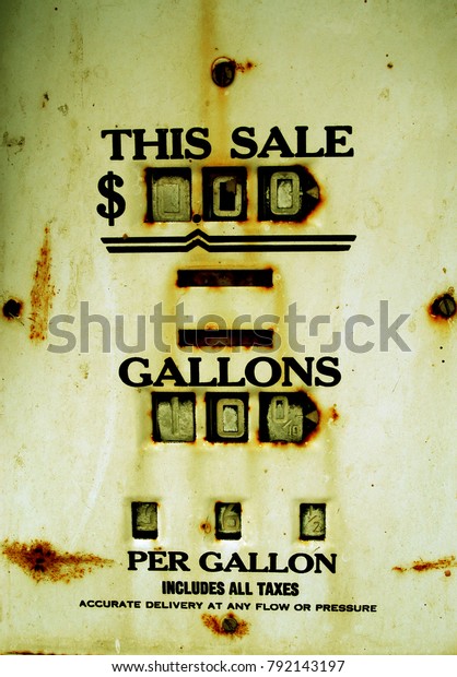 Old\
service station gas pump showing the dollar amount of the sale and\
the number of gallons pumped into the car. Old time vintage gas\
pump detail full of rust, broken with rusty\
screws.