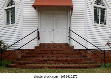 An Old Set Of Southern Church Doors With Brick Steps