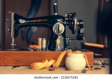 An Old Sewing Machine. Sewing On A Sewing Machine At Home. Equipment For Sewing And Repairing Clothes. Vintage Equipment For Seamstresses. Equipped Place For A Dressmaker.