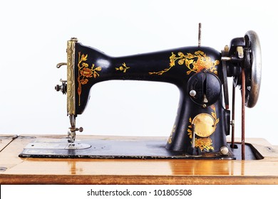 The old sewing machine on a white background