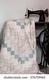 Old Sewing Machine And Patchwork Quilt