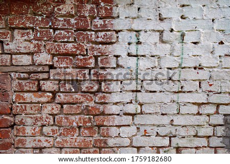 Old shabby brick wall of red and white colors.