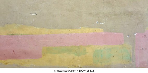 Old Shabby Concrete Grunge Wall With Peeled Plaster And Graffiti Wide Background Or Texture. Colorful Rough Building Facade With Grafiti. Abstract Web Banner For Design