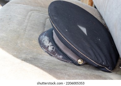 Old Shabby Postman Cap On A Car Seat As A Symbol Of Outdated Format Of Post Services