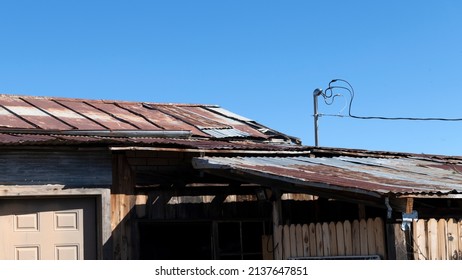 An Old Shack Metal Roof On A Blue Sky