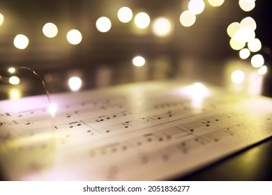 Old Sheet With Christmas Music Notes As Background, Bokeh Effect
