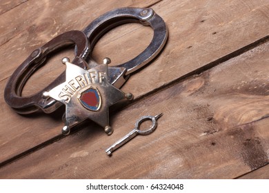 Old Sheriff Badge And Handcuffs