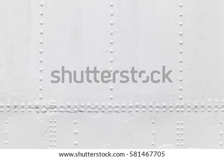 Old ship hull fragment, white metal sheets with rivets, background photo texture