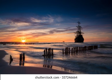 Old ship silhouette in sunset scenery