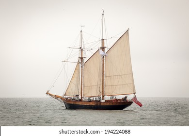 Old ship with white sales, sailing in the sea