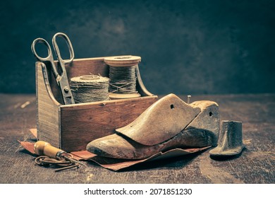 Old shoemaker workshop with tools, rules, leather and strap. Old shoemaker workshop