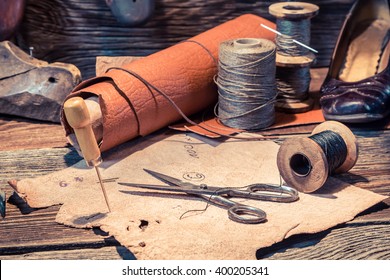 Old shoemaker workshop with tools, shoes and laces - Powered by Shutterstock