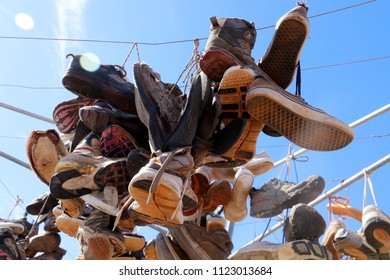 Old shoes hanging on a hills hoist.