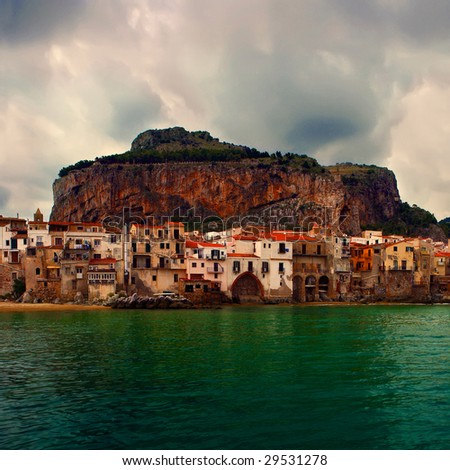 Old Sicilian city of Cefalu of the coastal Terensky sea - from port.