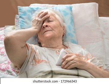 Old Sick Woman Lying At Bed