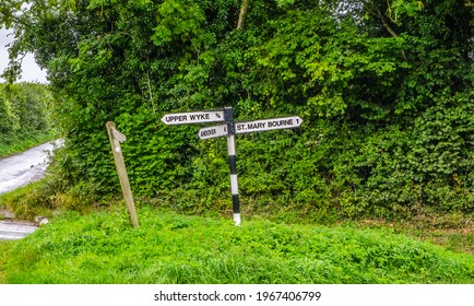 Old sign post pointing to St Mary Bourne and Andover, Hampshire. Black lettering on white background