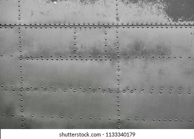 Old silver metal surface of the aircraft fuselage with rivets