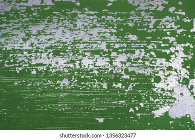 Old Silver Metal Wall With Peeled Off And Scratched Green Paint.