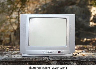 An Old Silver TV Set Stands In The Woods. Vintage TVs 1980s 1990s 2000s. 