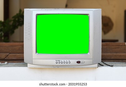 An Old Silvery Green-screen TV For Adding Video Sits In An Abandoned Hotel. Vintage TVs 1980s 1990s 2000s. 