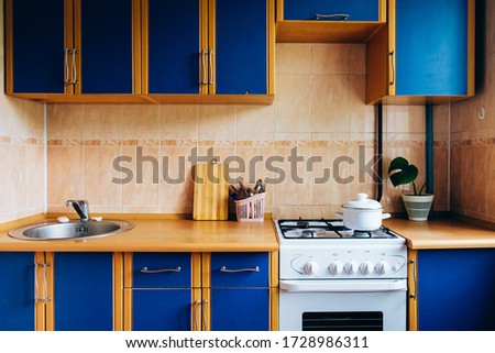 Old simple kitchen interior design with ugly messy cabinets  in need of remodel.