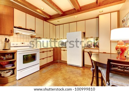 Old simple white and wood kitchen interior with hardwood floor.