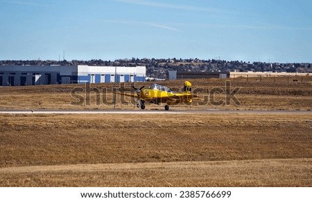 An Old Single Engine Trainer Airplane Landing on a Runway