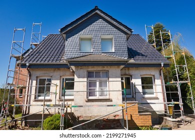 Old single-family house with scaffolding is being renovated
 - Shutterstock ID 2199271945