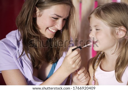 Image, Stock Photo Sisters, teenage girl and her younger sister pushing hay bale playing together outdoors in the countryside