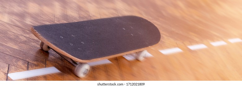 old skateboard located on brown wooden parquet boards with white lines at bright summer sunlight close view - Powered by Shutterstock