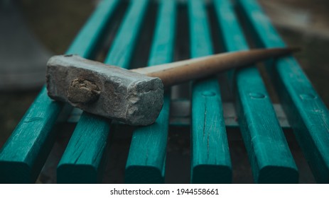 An Old Sledgehammer On A Bench In The Spring