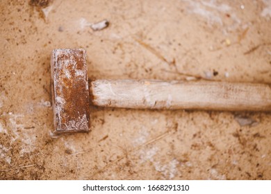 Old Sledgehammer On The Ground Background 
