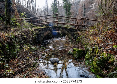 old small stone bridge over an alpine stream on an alpine trail in Val Brenbana in Lombardy Italy - Powered by Shutterstock