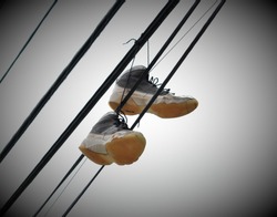 Old Sneakers Hanging From Telephone Wires