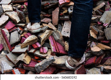 Old Sneakers On A Pile Of Bricks