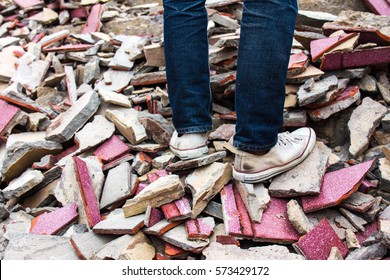 Old Sneakers On A Pile Of Bricks