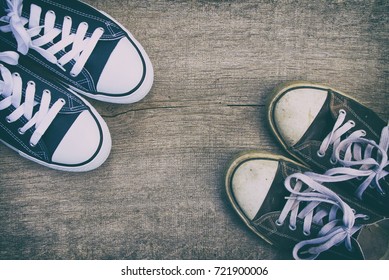 Old Sneakers Vs New Sneakers, Canvas Shoes On A Wooden Board. Trendy Footwear. Top View.