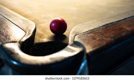 Old snooker ball that is on the snooker table.