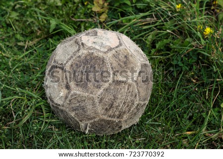 Old soccer ball in the grass
