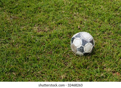 Old Soccer Ball On Grass