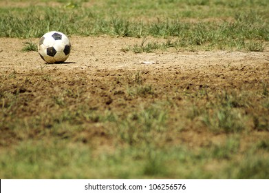 Old Soccer Ball. Poor School Soccer Field. Charity.