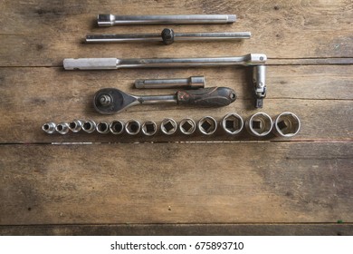 Old Socket Wrench Set On Wood Background,Select Focus,Top View
