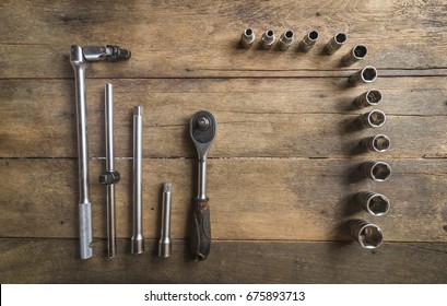 Old Socket Wrench Set On Wood Background,Select Focus,Top View
