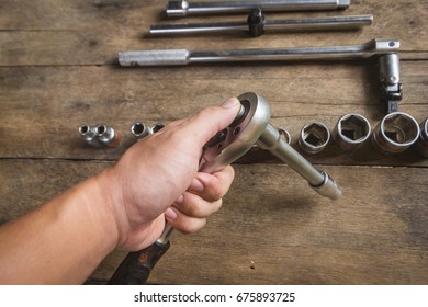 Old Socket Wrench Set On Wood Background,Select Focus
