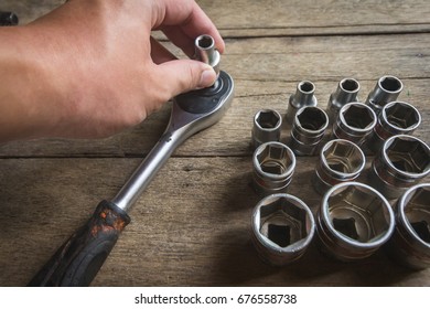 Old Socket Wrench Set On Wood Background,Select Focus