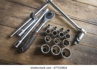 Old Socket Wrench Set On Wood Background,Select Focus
