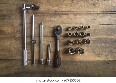 Old Socket Wrench Set On Wood Background,Select Focus
