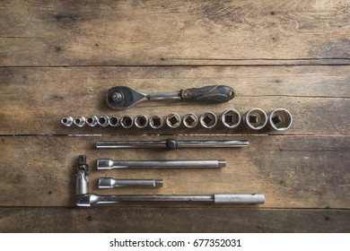 Old Socket Wrench Set On Wood Background,Select Focus
