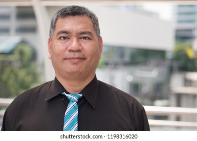 Old South East Asian Business Man Face; Portrait Of Happy Smiling Old Senior Southeast Asian Businessman, Formal Office Worker With Grey Hair; South East Asian Middle Age To Senior Man Model