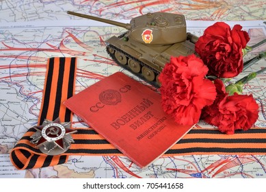 Old Soviet military ID , order of the Patriotic War in St. George's bow, the model of the T-34 and carnations are living on a military map of the liberation of Poland